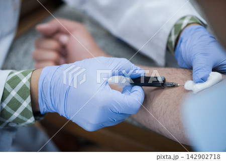 Middle Eastern doctors and technician performing blood test and venipuncture in clinical laboratory setting Middle Eastern doctors and technician performing blood test and venipuncture in clinical laboratory setting 142902718