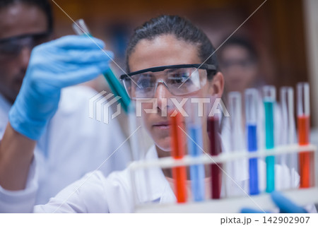 Middle Eastern young doctors and medical technician performing blood testing in a clinical laboratory Middle Eastern young doctors and medical technician performing blood testing in a clinical laboratory 142902907