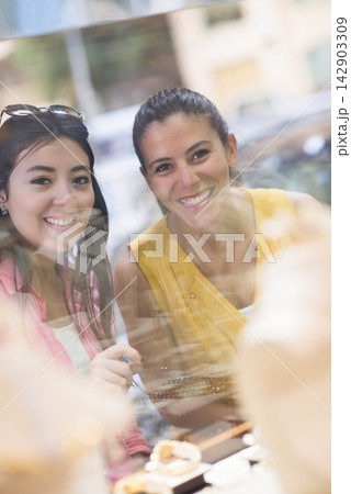 Middle Eastern couple shopping for a wedding ring with friends and family, smiling in a jewelry store Middle Eastern couple shopping for a wedding ring with friends and family, smiling in a jewelry store 142903309