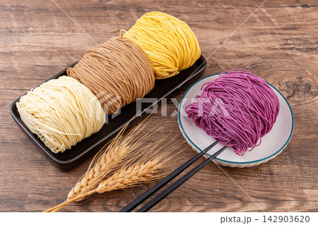 assorted Colored Dried Cantonese Jook Sing Noodle Cakes 142903620