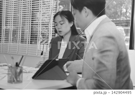 Business professional analyzing financial data on digital tablet dashboard with calculator and laptop, representing accounting software, ERP system integration, performance monitoring. 142904495