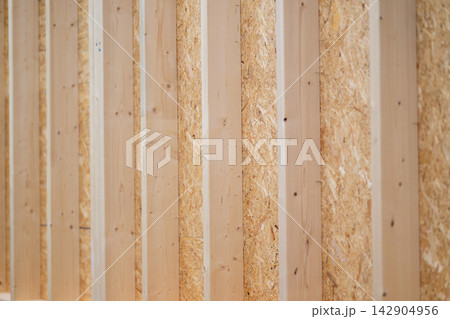 Interior wall framing with wooden studs and oriented strand board panels in new construction project Interior wall framing with wooden studs and oriented strand board panels in new construction project 142904956