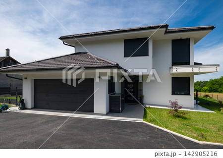 Modern modular minimalist two-story house with double garage, solar panels and energy-efficient design 142905216