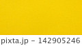Yellow paper texture background with fine grain and fibers across a blank vivid matte surface 142905246