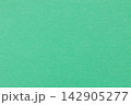 Mint green paper background with fine grain texture across a blank matte monochrome surface 142905277