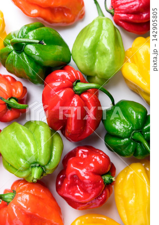Bright habanero peppers close up on white background Bright habanero peppers close up on white background 142905805