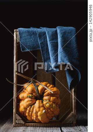 Ornamental gourds arranged inside rustic wooden crate Ornamental gourds arranged inside rustic wooden crate 142905946