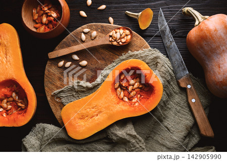 Top view of raw butternut squash with wooden spoon Top view of raw butternut squash with wooden spoon 142905990