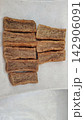 Top view of deep fried rectangular fish cracker slices on a white plate 142906091