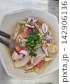 Top view of traditional Thai seafood noodle soup with prawns, squid, and lemongrass 142906136