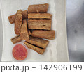 Crispy fried Malaysian fish crackers known as Keropok Lekor with chili sauce 142906199