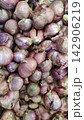 High angle view of many fresh raw shallots in a market bin 142906219