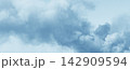 Soft blue sky with light fluffy clouds 142909594