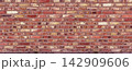 Red brick wall displaying rustic textured surface 142909606