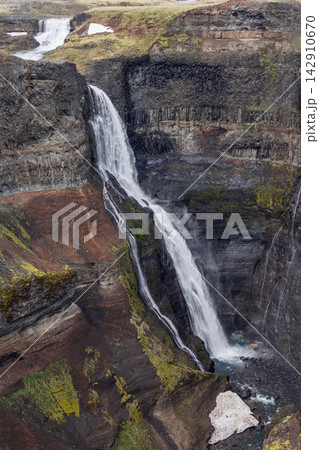 Granni waterfall and upper cascade in a steep layered canyon in Iceland Granni waterfall and upper cascade in a steep layered canyon in Iceland 142910670