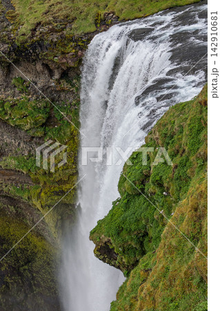 Skogafoss waterfall and green cliffs beside the Skoga River in South Iceland 142910681