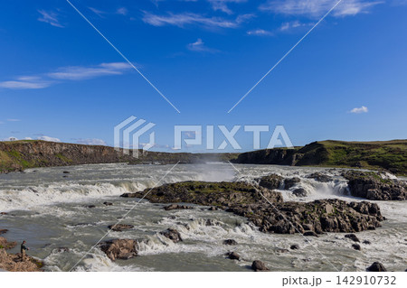 Urridafoss waterfall on the Thjorsa River in Iceland with rapids and a lone angler Urridafoss waterfall on the Thjorsa River in Iceland with rapids and a lone angler 142910732