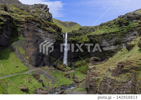 Kvernufoss waterfall and rocky stream between green canyon walls in Iceland Kvernufoss waterfall and rocky stream between green canyon walls in Iceland 142910813