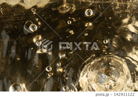 Wave and bubbles on yellow water surface Wave and bubbles on yellow water surface 142911122