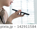 Young Businesswoman Working at Office Desk While Managing Documents and Mobile Communication. 142911584