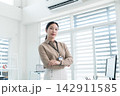 Young Businesswoman Working at Office Desk While Managing Documents and Mobile Communication. 142911585