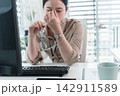 Young Businesswoman Working at Office Desk While Managing Documents and Mobile Communication. 142911589
