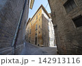 A narrow, cobblestone street in Urbino, Italy 142913116