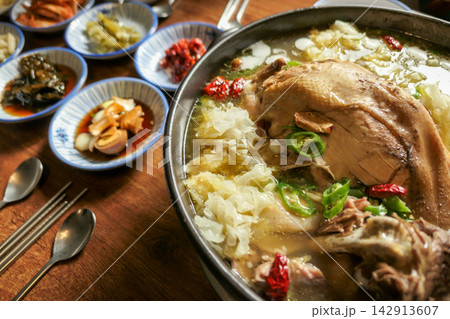 Korean Herbal Whole Duck Soup with Tremella Mushroom and Chili Peppers 142913607