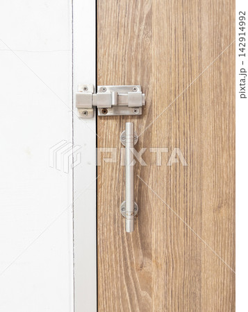 Stainless Steel Slide Latch on Wooden Door 142914992