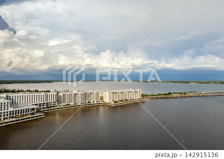 Subtropical hurricane storm sweeping over tourist resort on bay shore. Interrupted vacations and closed facilities due to storm. Subtropical hurricane storm sweeping over tourist resort on bay shore. Interrupted vacations and closed facilities due to storm. 142915136