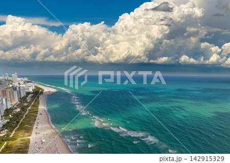 Miami Beach city with high luxury hotels and condos and sandy beachfront. High angle view of tourist infrastructure in southern Florida, USA 142915329