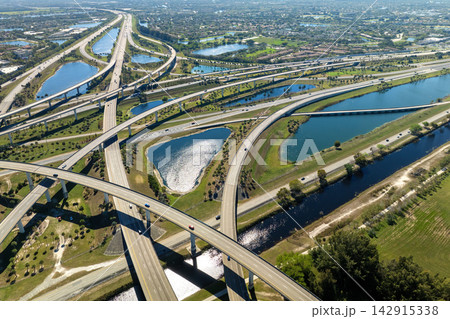 USA car urban transportation infrastructure. American highway junction with fast driving vehicles in Miami, Florida USA car urban transportation infrastructure. American highway junction with fast driving vehicles in Miami, Florida 142915338