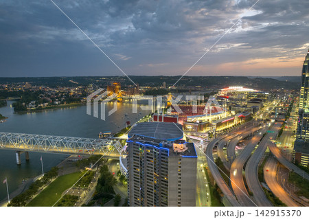 Cincinnati, Ohio, modern American city with highway junction at night with fast driving cars. Aerial view of USA urban infrastructure Cincinnati, Ohio, modern American city with highway junction at night with fast driving cars. Aerial view of USA urban infrastructure 142915370