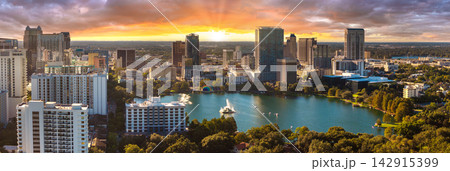 Orlando, Florida at sunset. American city downtown architecture with Lake Eola Park and high-rise office buildings. Real estate development in Florida. USA travel destination. Orlando, Florida at sunset. American city downtown architecture with Lake Eola Park and high-rise office buildings. Real estate development in Florida. USA travel destination. 142915399