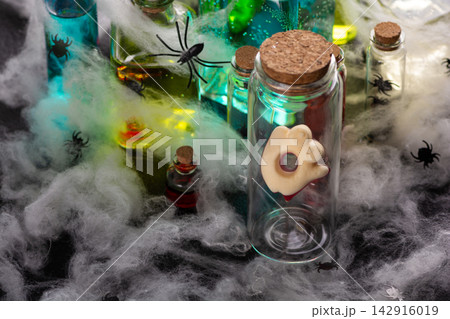 Halloween spooky potion bottles with spiders and cobwebs for decoration Halloween spooky potion bottles with spiders and cobwebs for decoration 142916019