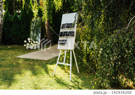 Wedding stand with stylish black heart-shaped sunglasses for guests outdoors. Wedding stand with stylish black heart-shaped sunglasses for guests outdoors. 142916200