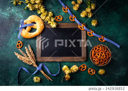 Oktoberfest background with brezel, hops and malt Oktoberfest background with brezel, hops and malt 142916852