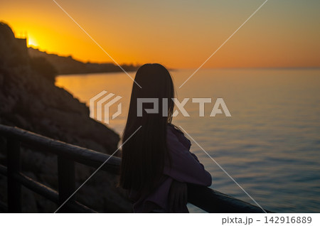 Sunrise over the sea in Rincon de la Victoria, Malaga, Spain, with golden light reflecting on calm waves along the coast. Sunrise over the sea in Rincon de la Victoria, Malaga, Spain, with golden light reflecting on calm waves along the coast. 142916889