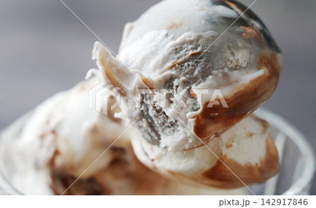 Hands Scooping A Round Portion Of Delicious Ice Cream With Topping Using An Ice Cream Scoop 142917846