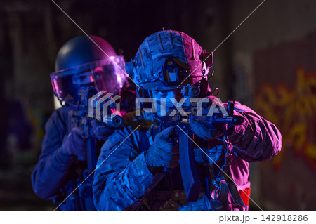 Tactical Soldiers in Urban Night Raid With Rifles and Riot Gear Team in Low Light Tactical Soldiers in Urban Night Raid With Rifles and Riot Gear Team in Low Light 142918286