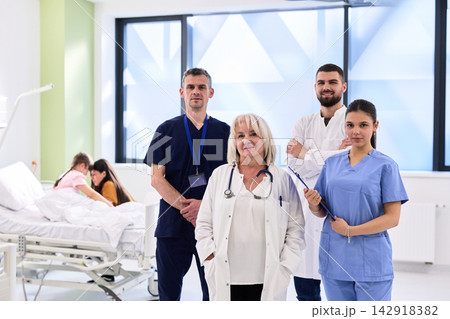 Medical team in a hospital setting working together to provide patient care and support in a bright, modern environment 142918382