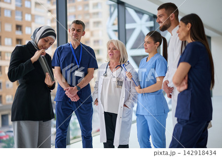 Healthcare team discusses patient care in modern hospital setting during daytime 142918434