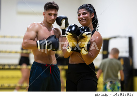Confident Female Boxer And Male Partner During Boxing Training And Sparring Session In Gym Confident Female Boxer And Male Partner During Boxing Training And Sparring Session In Gym 142918918