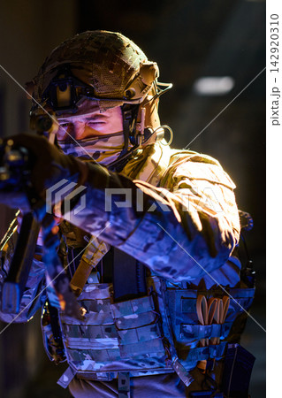 Tactical Soldier Aiming Rifle in Night Operation Wearing Military Gear and Helmet Tactical Soldier Aiming Rifle in Night Operation Wearing Military Gear and Helmet 142920310