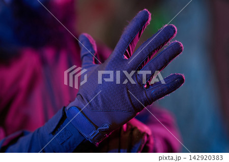 Close-Up Of Gloved Hand In Neon Light Showing Winter Outdoor Tactical Glove With Velcro Strap Close-Up Of Gloved Hand In Neon Light Showing Winter Outdoor Tactical Glove With Velcro Strap 142920383