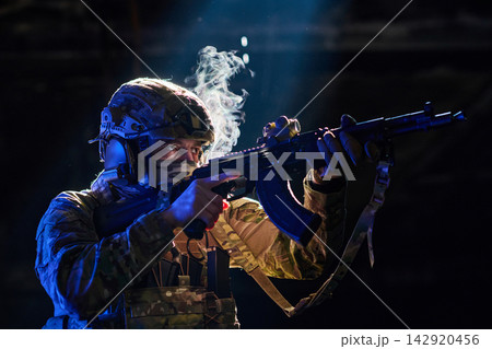 Soldier Aiming Assault Rifle in Dark Tactical Environment With Smoke and Dramatic Blue Lighting Soldier Aiming Assault Rifle in Dark Tactical Environment With Smoke and Dramatic Blue Lighting 142920456