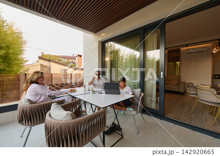Family Working Together On Modern Home Balcony Terrace With Laptop Near Living Room Family Working Together On Modern Home Balcony Terrace With Laptop Near Living Room 142920665