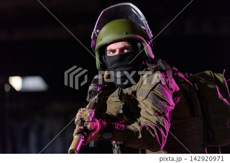Armed Soldier In Tactical Gear Aiming Rifle During Night Special Forces Operation Armed Soldier In Tactical Gear Aiming Rifle During Night Special Forces Operation 142920971