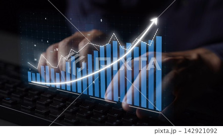 Hands Typing on Keyboard with Overlay of Graph and Data Chart Depicting Financial Increase and Growth Trend in Digital Environment Copula 142921092