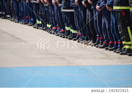 Row Of Firefighters Standing in Uniform Line Formation During Ceremony Showing Teamwork And Discipline 142921421